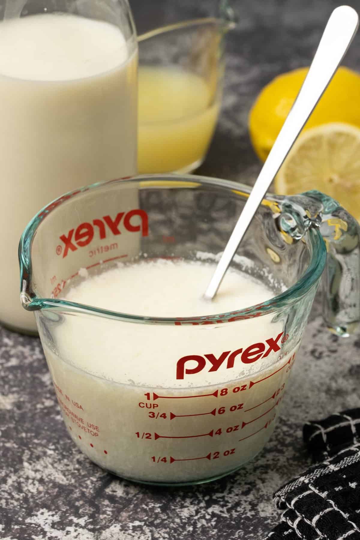 Homemade buttermilk in a glass measuring jug. 