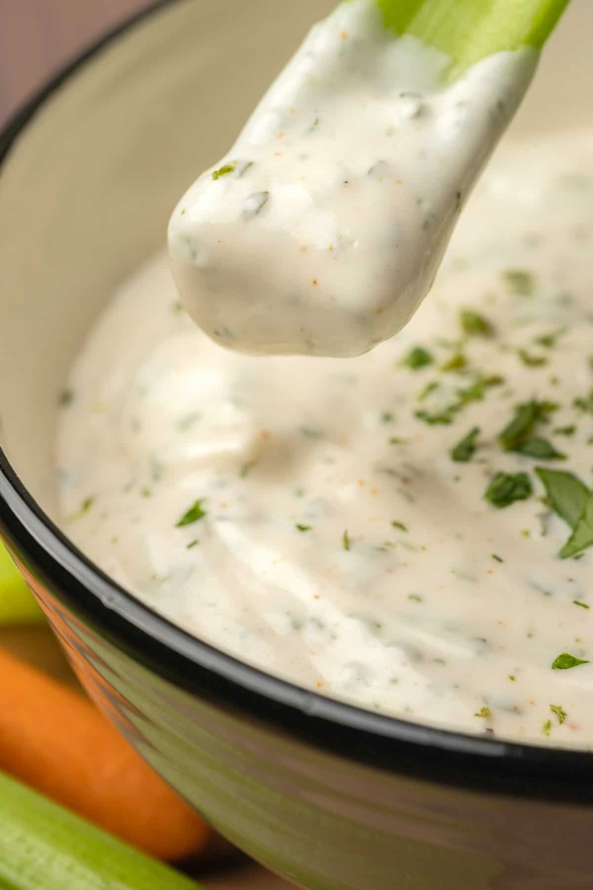 Celery stick covered in ranch dressing.