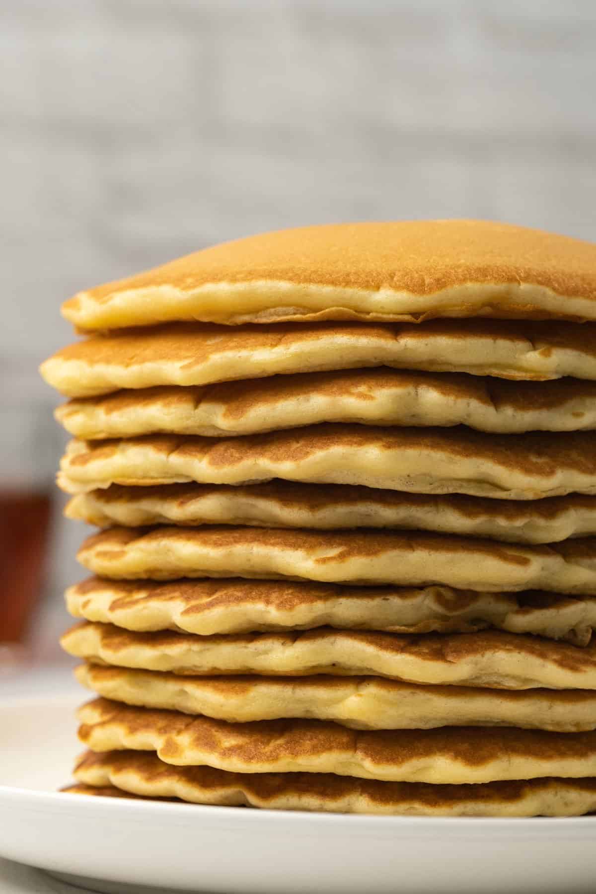 Stack of pancakes on a white plate. 