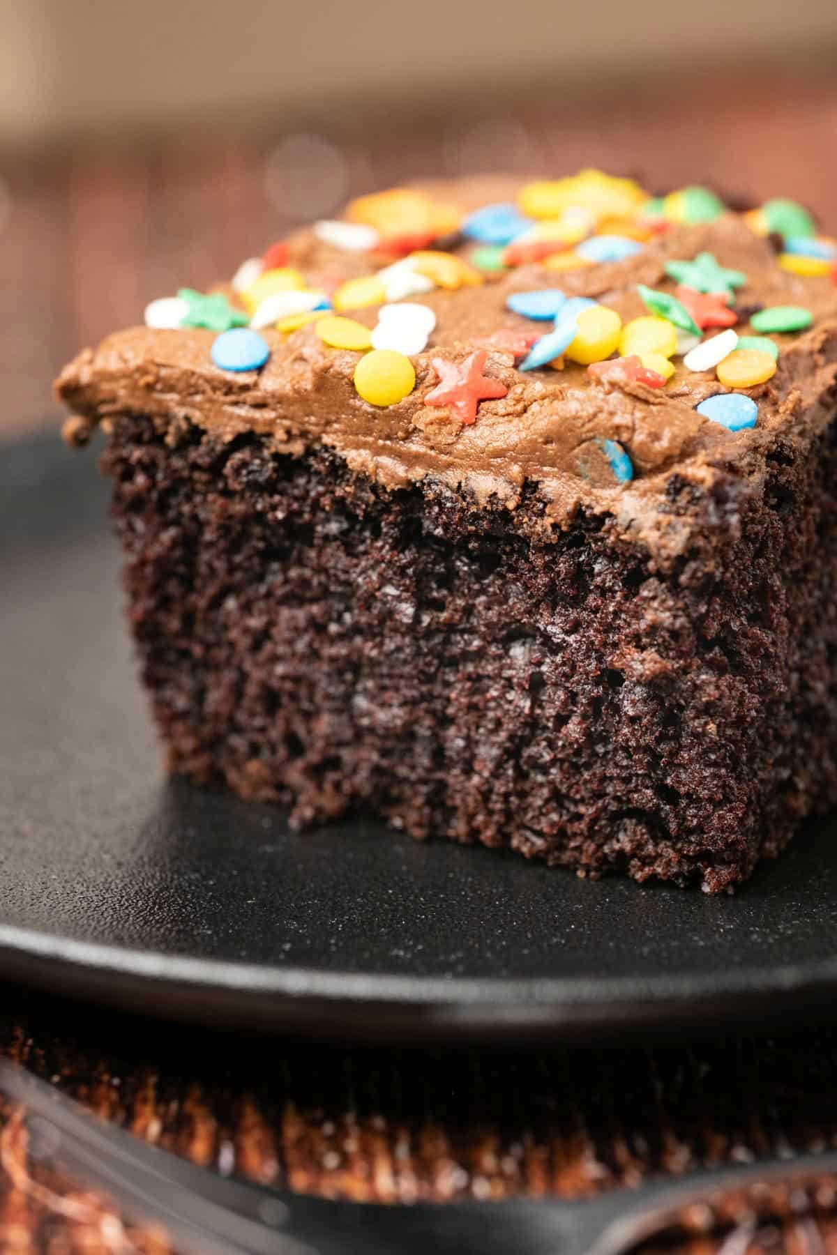 Slice of chocolate wacky cake on a plate. 