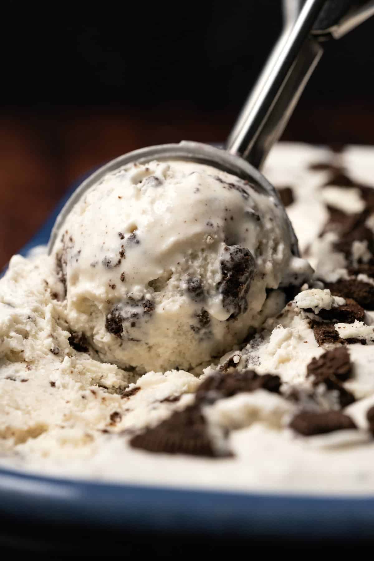 Scooping ice cream with a silver ice cream scoop. 