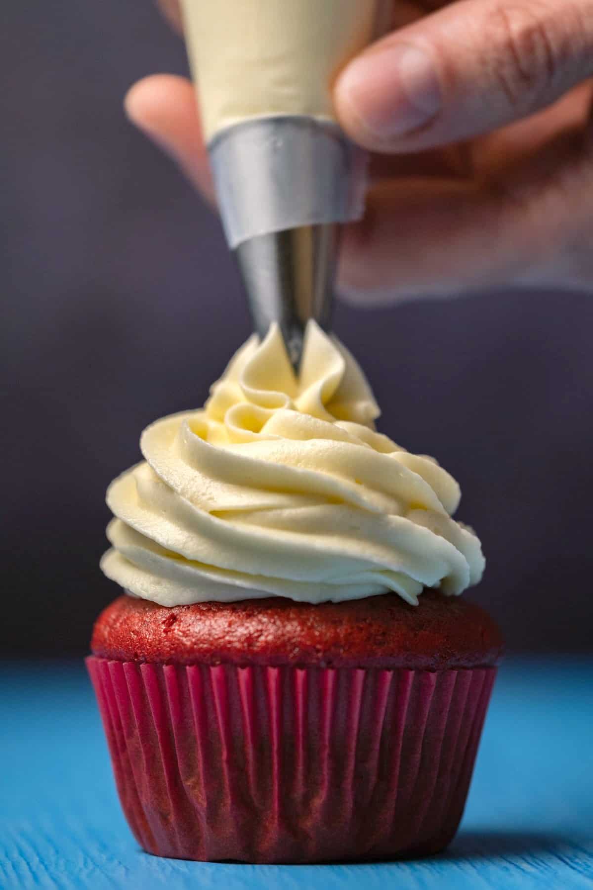 Frosting piping onto a cupcake. 