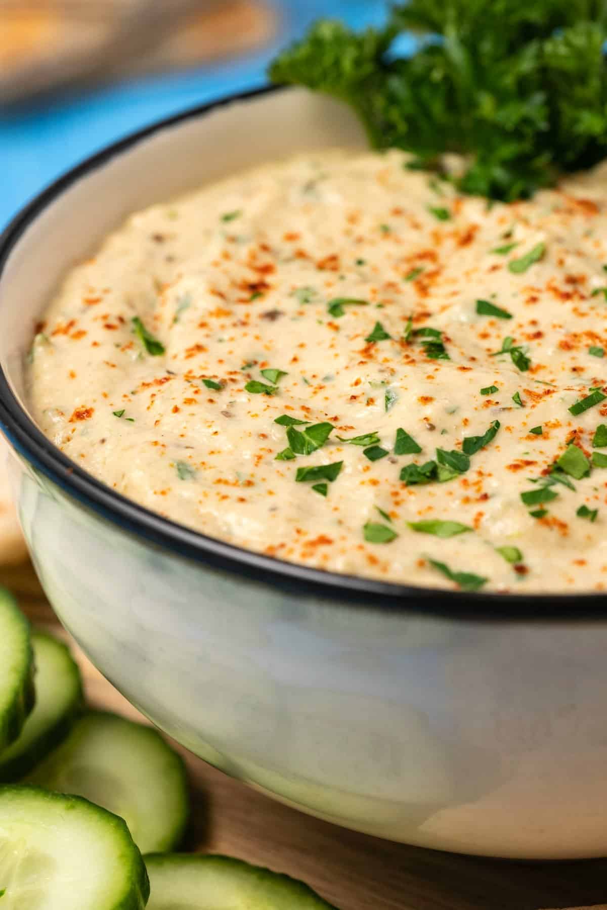 Baba ganoush in a ceramic bowl with fresh parsley. 