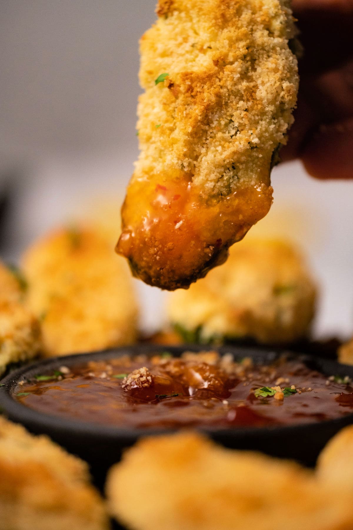 Baked jalapeño popper dipped in sweet chili sauce. 