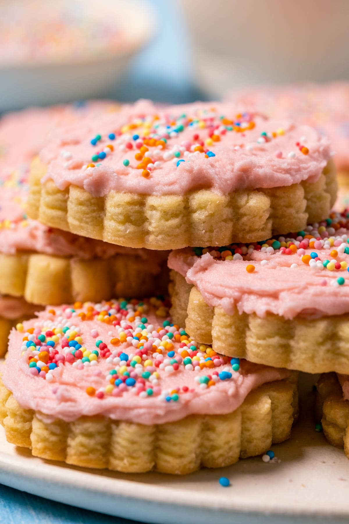 Eggless sugar cookies stacked up on a plate.
