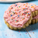 Eggless sugar cookie leaning against a stack of cookies.