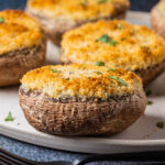 Vegetarian stuffed mushrooms on a white plate.