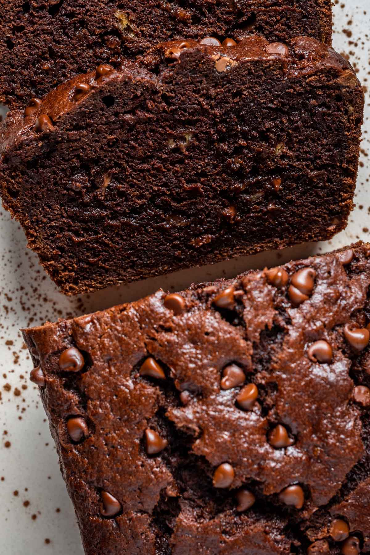 Sliced loaf of double chocolate banana bread on a white plate.