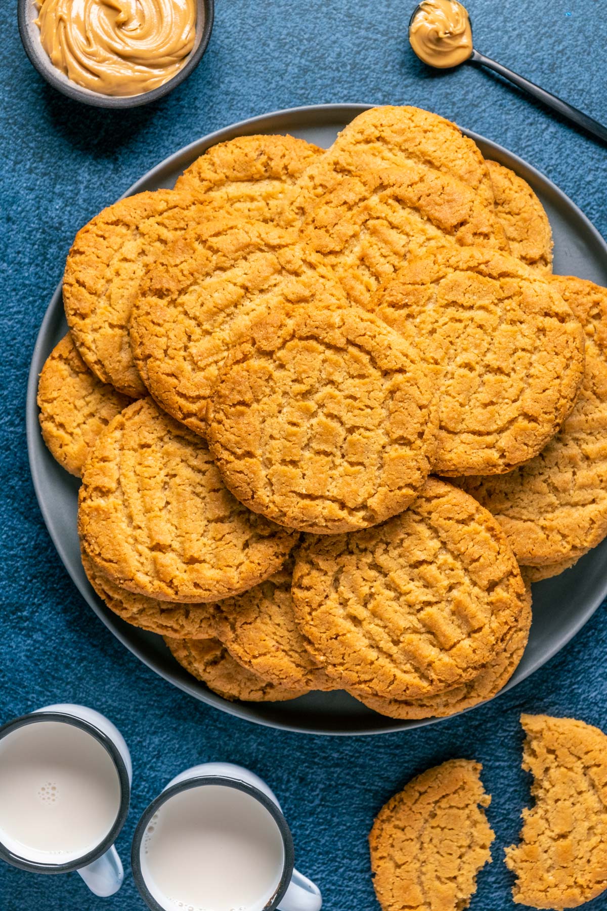 Peanut butter almond flour cookies stacked up on a plate. 
