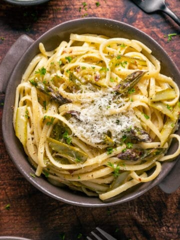 Asparagus pasta topped with parmesan in a bowl.
