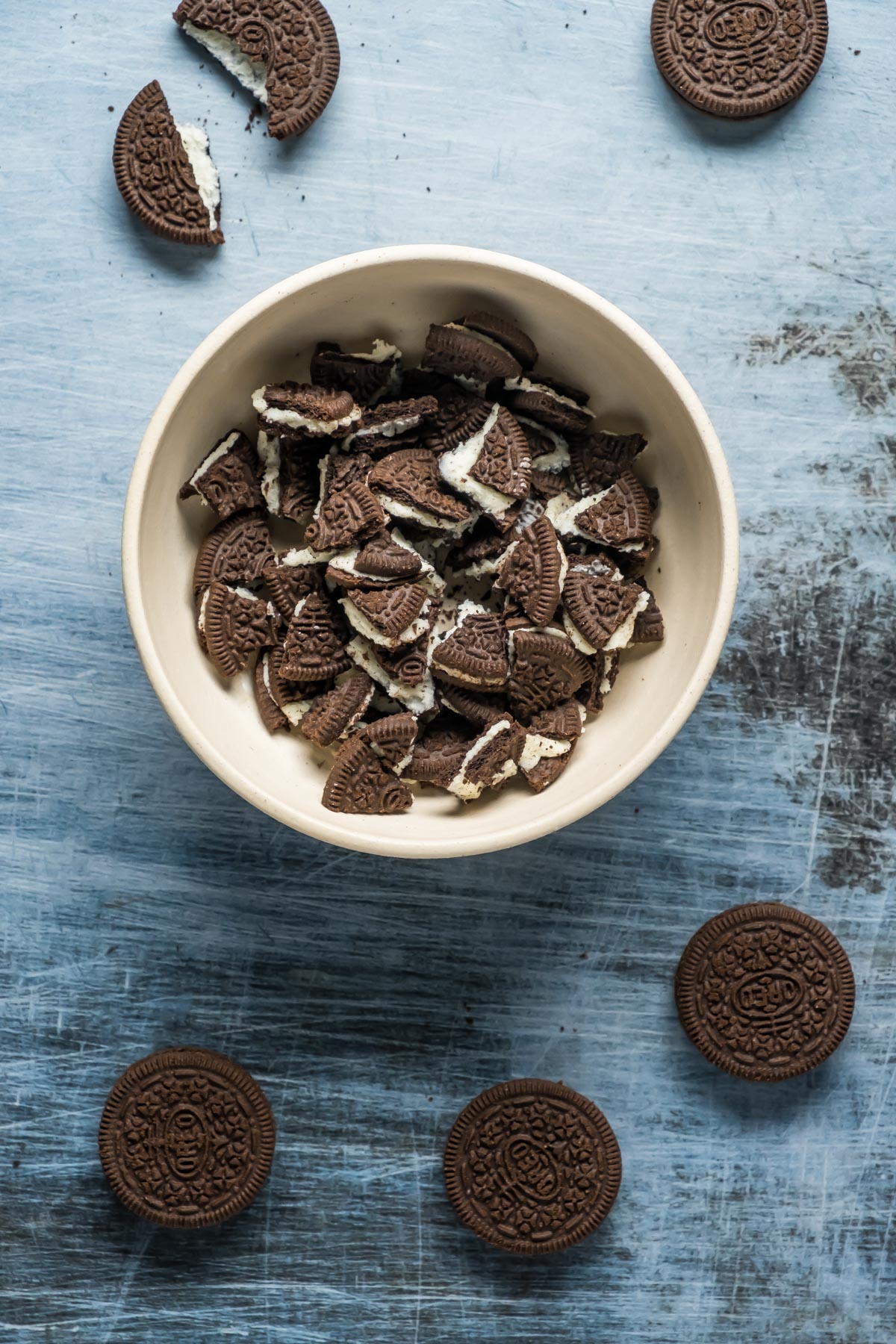 Oreo pieces broken up in a white bowl.