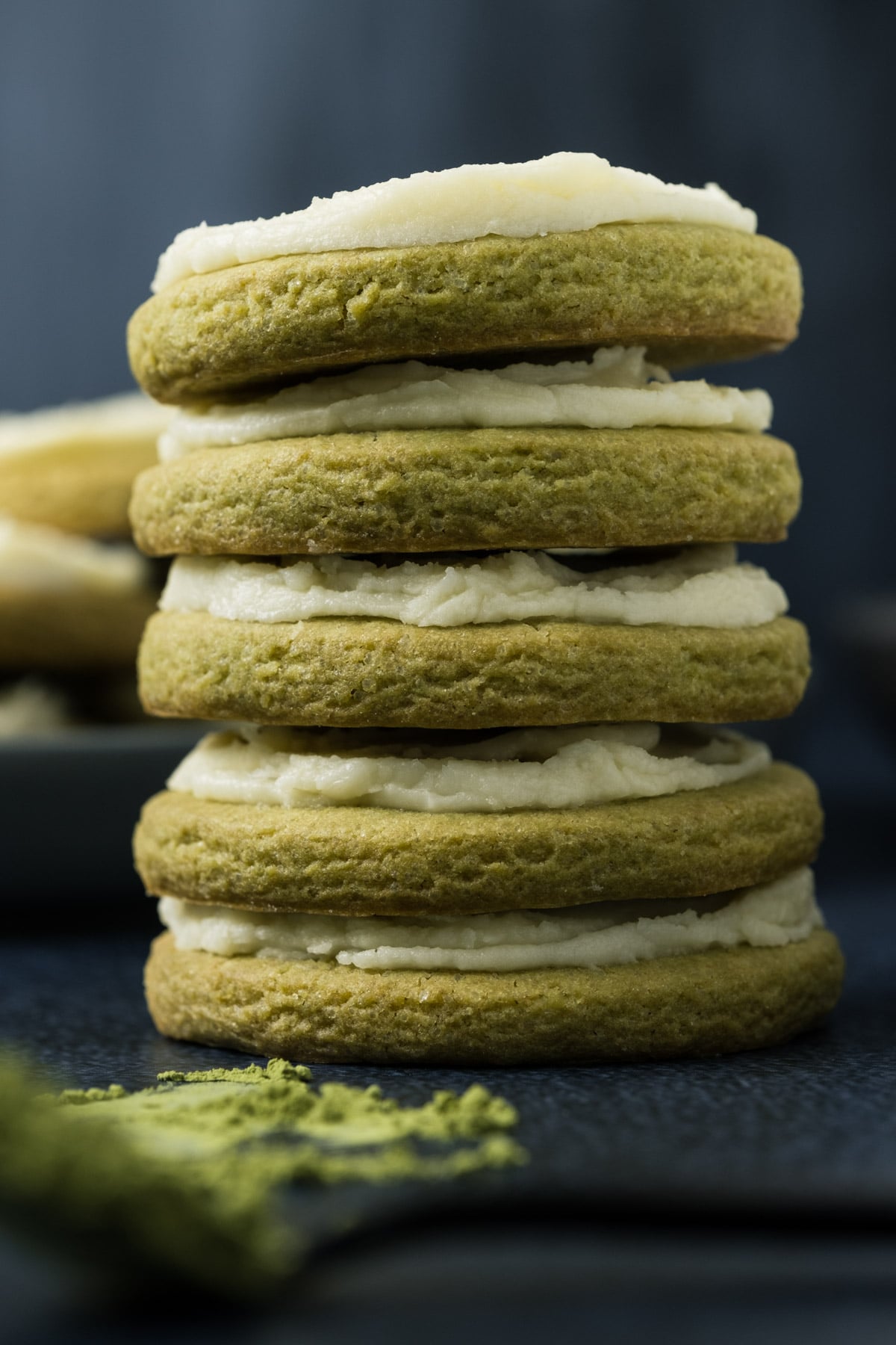 Frosted matcha cookies in a stack.