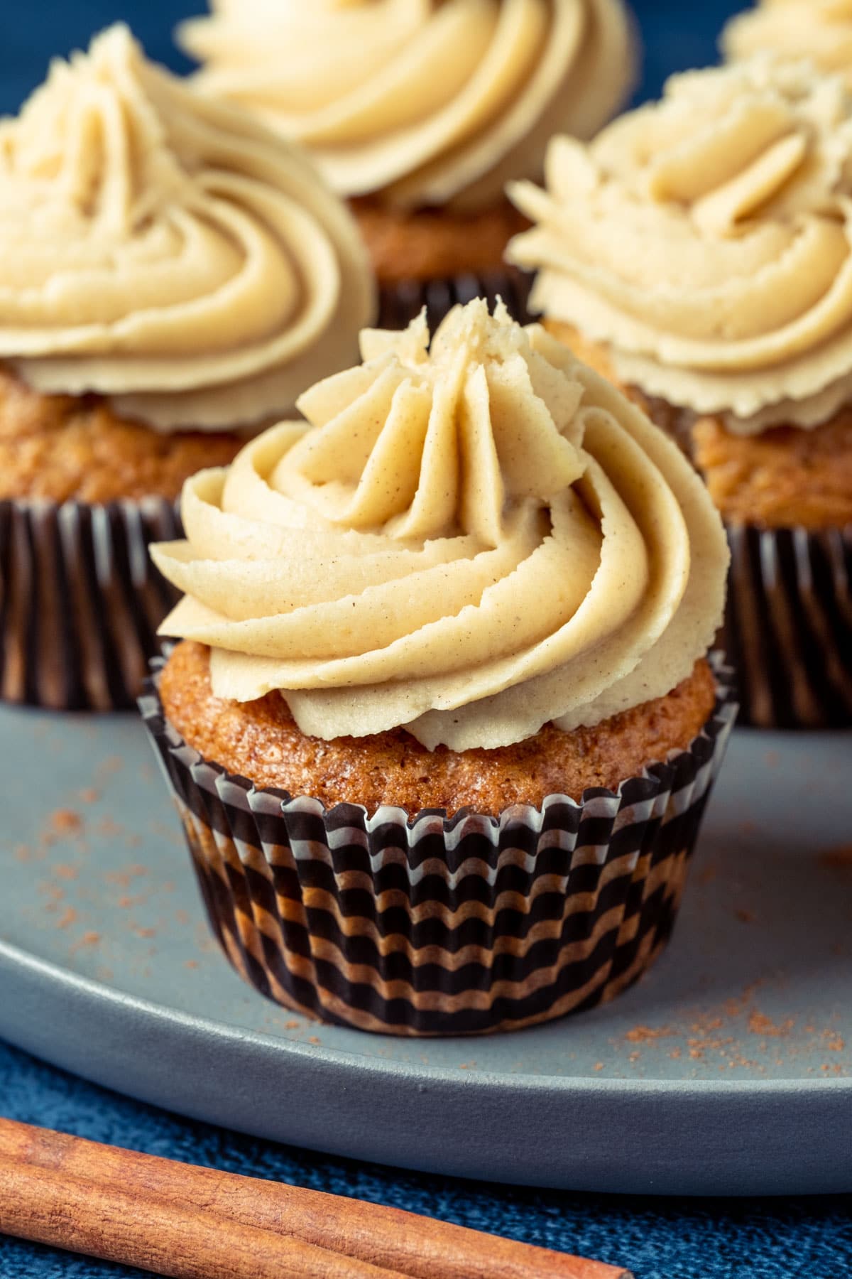 Frosted cinnamon cupcakes on a plate.