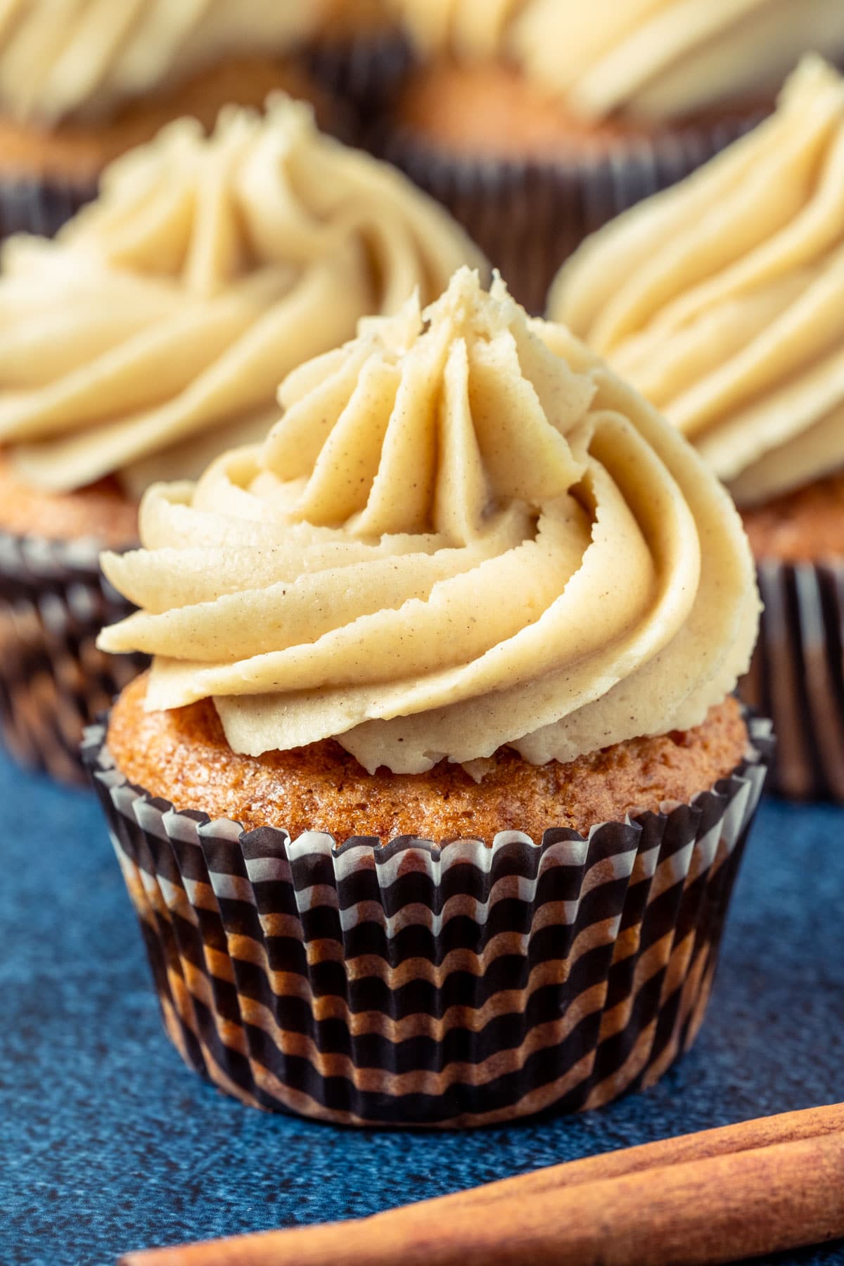 Cinnamon cupcakes topped with cinnamon frosting.