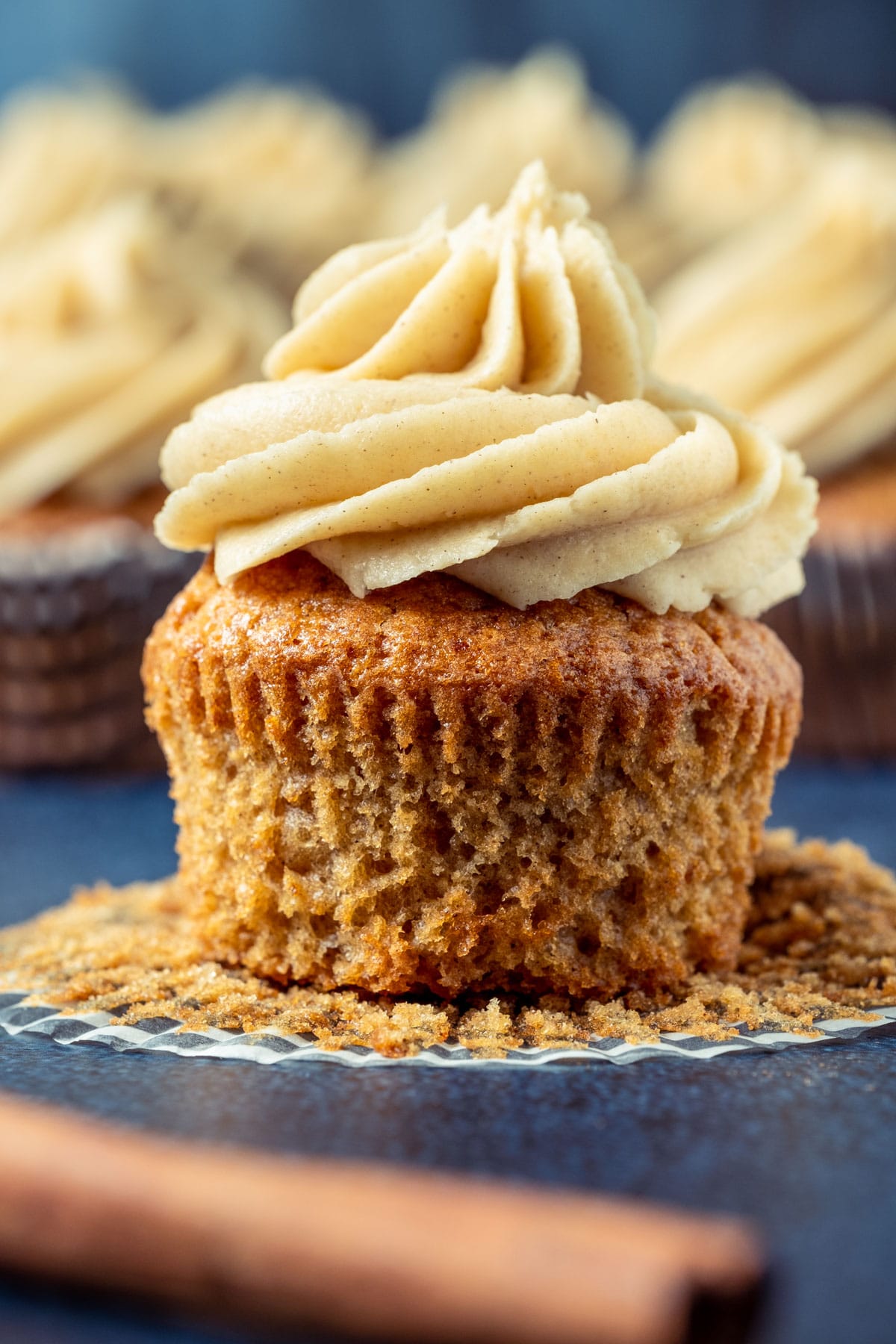 Cinnamon cupcake with the cupcake liner pulled down.