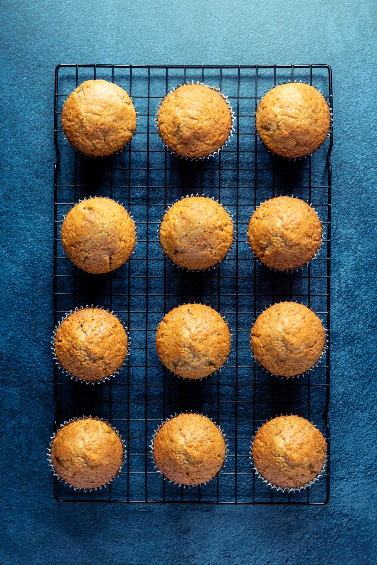 Cinnamon cupcakes on a wire cooling rack.