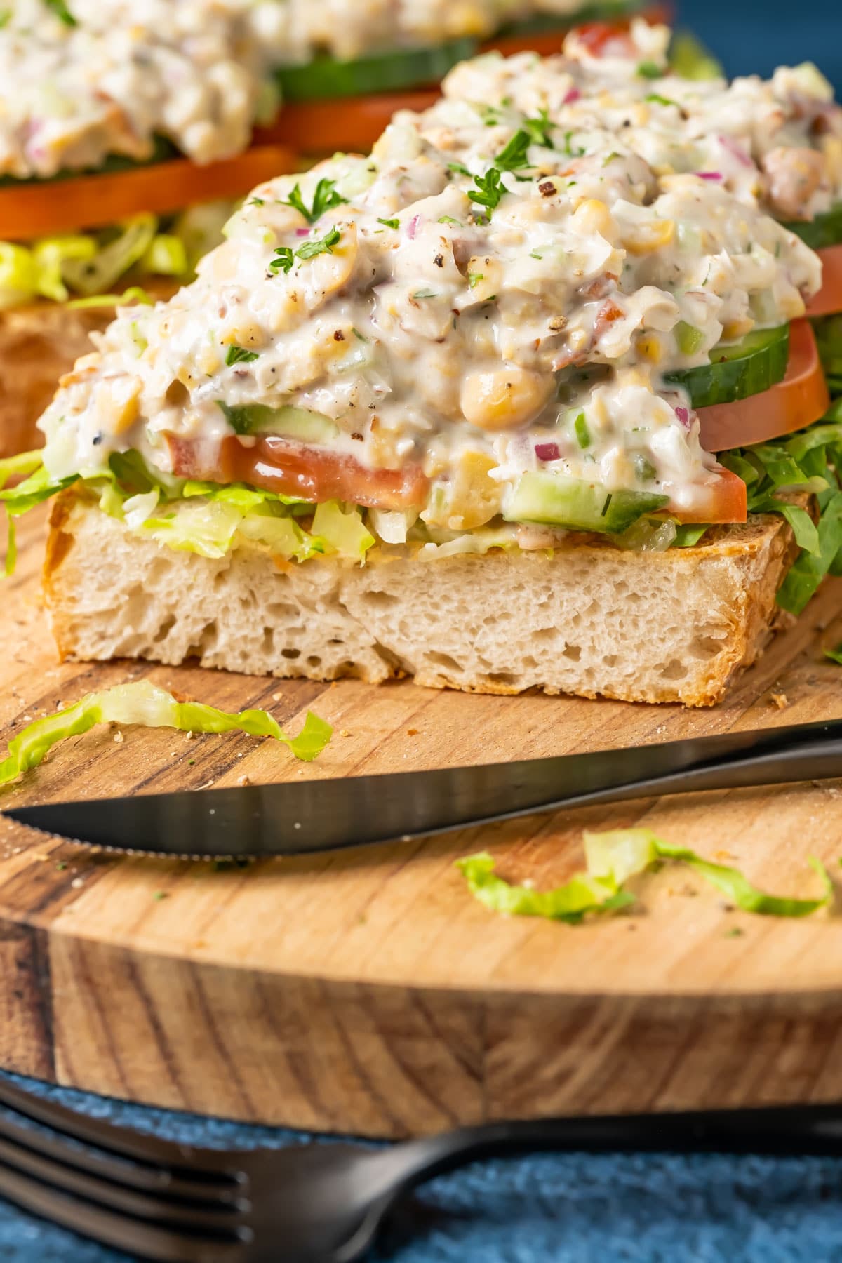 Chickpea chicken salad open faced sandwich cut in half.