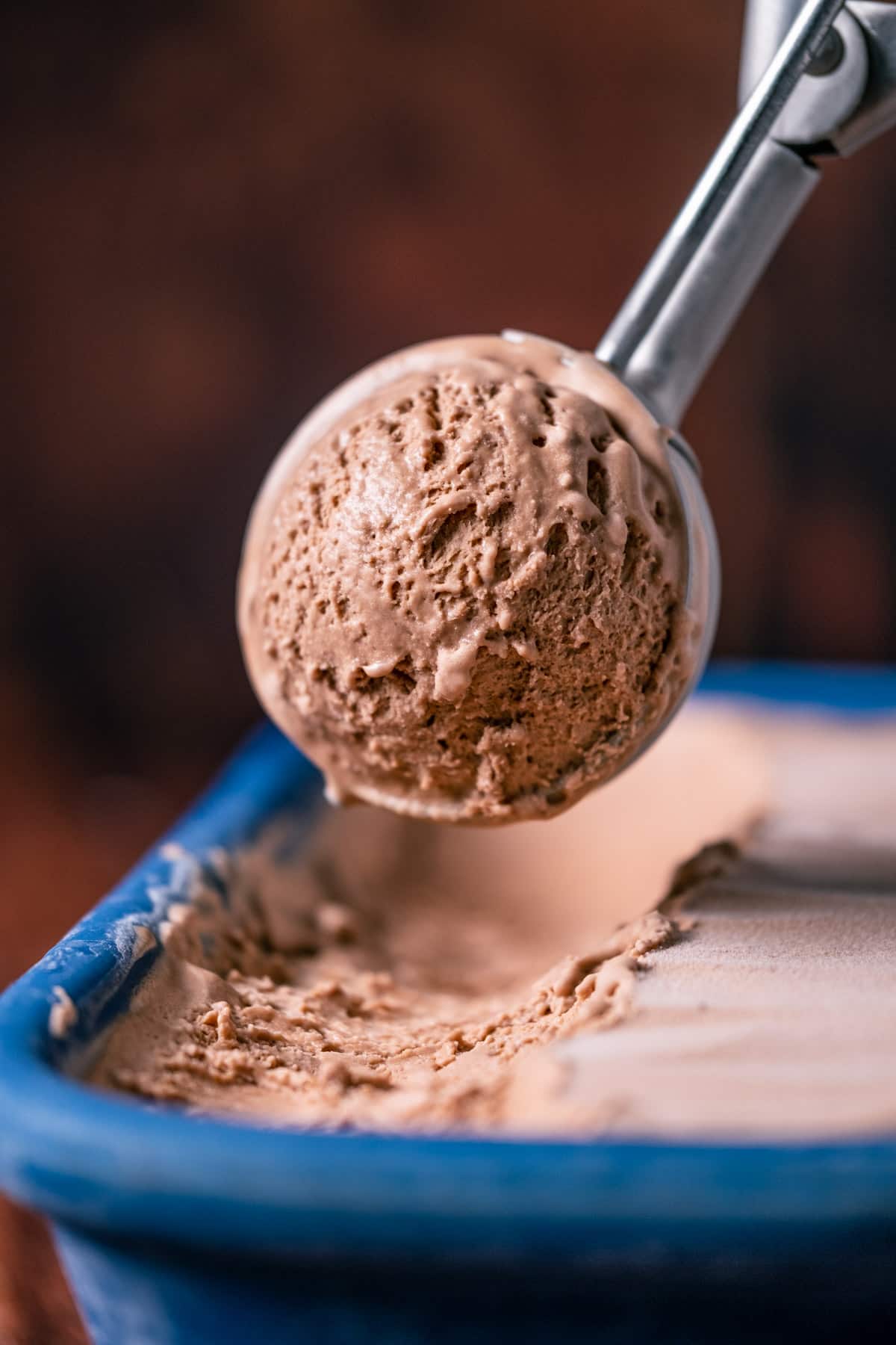 Scooping ice cream with an ice cream scoop.