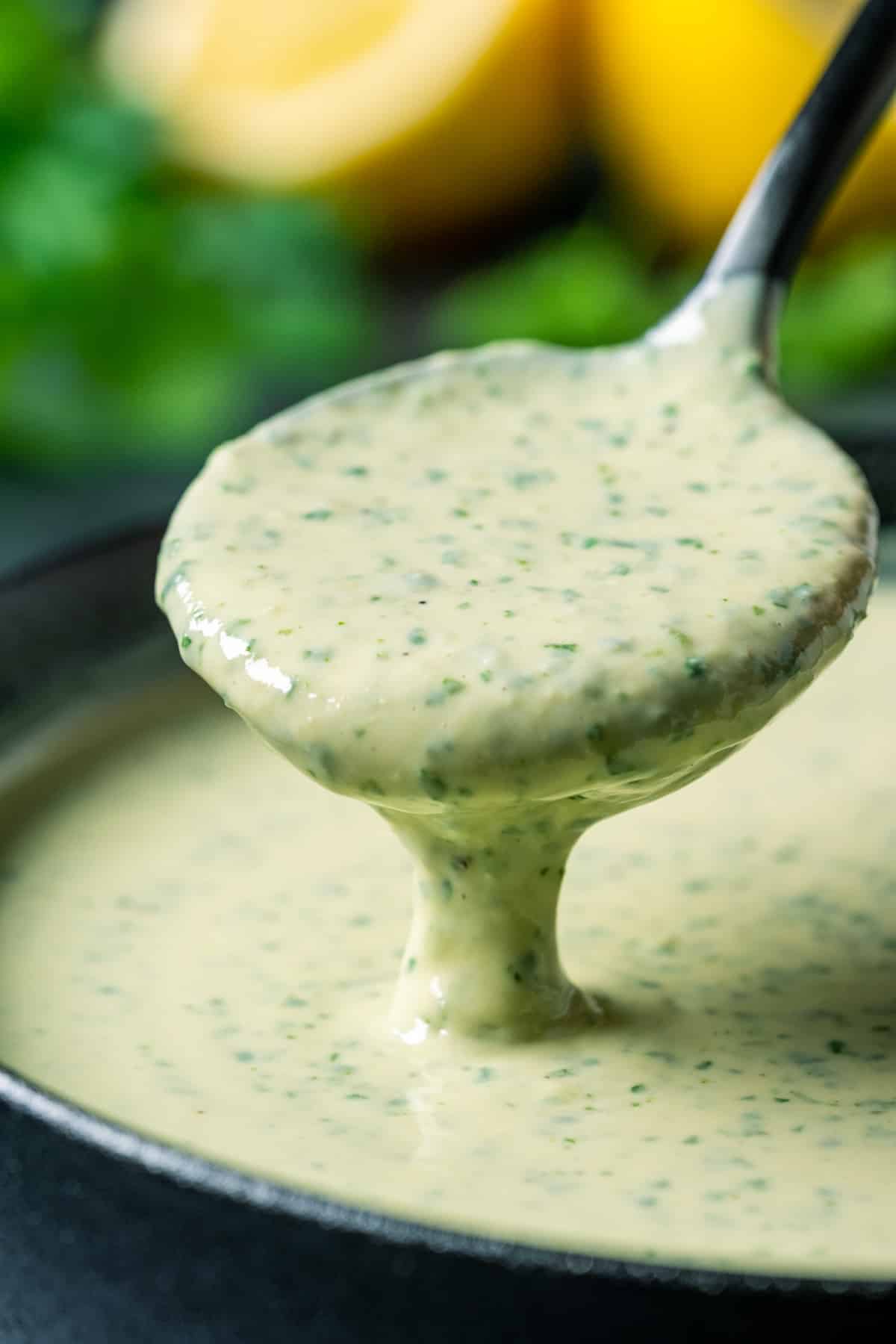 Spoonful of lemon herb tahini sauce. 