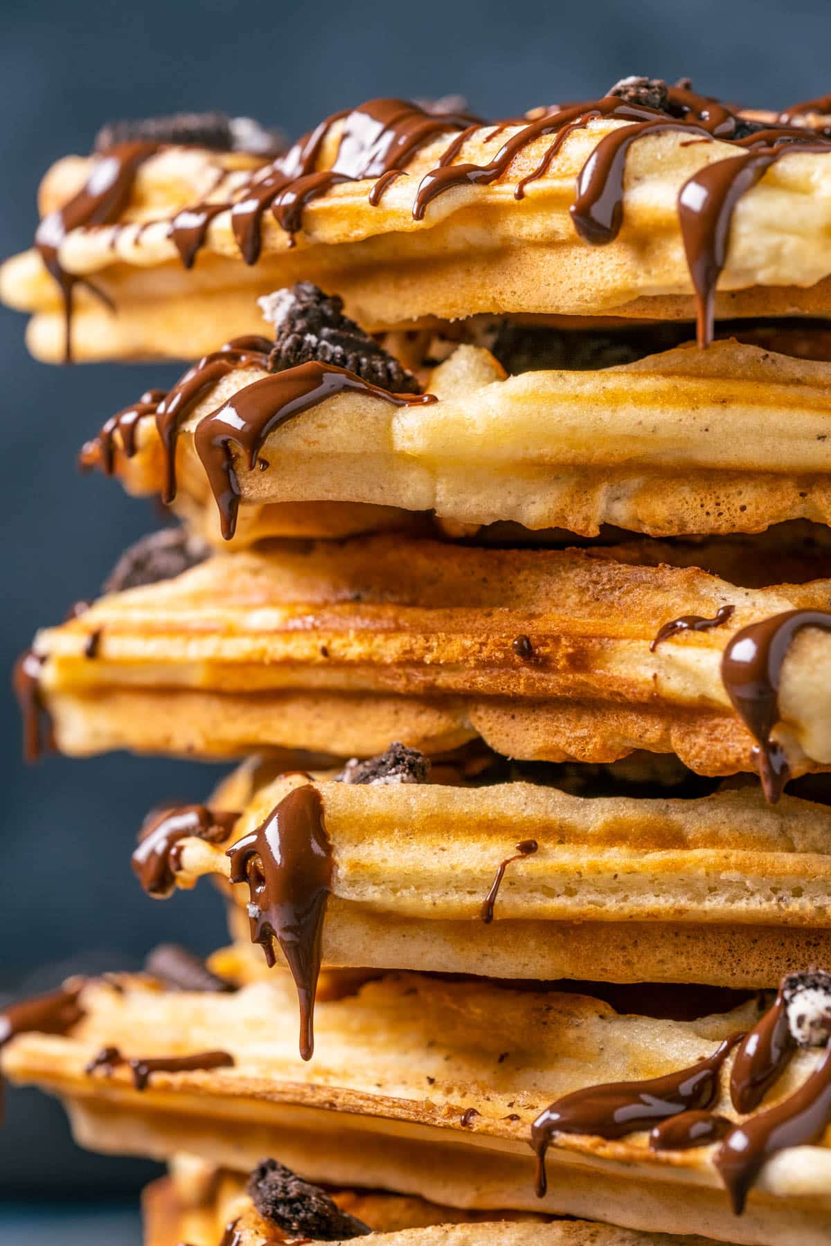 Stack of Oreo waffles drizzled with melted chocolate.