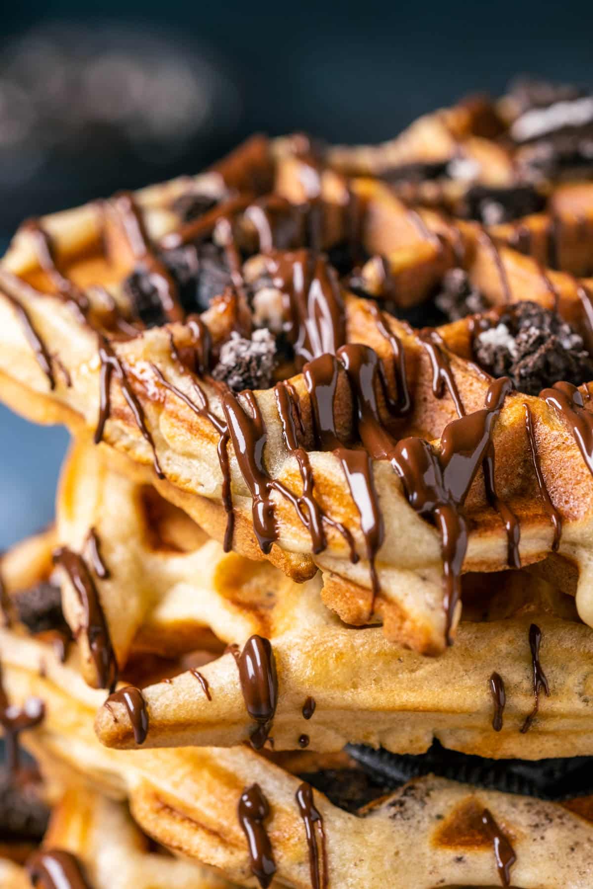 Stack of Oreo waffles drizzled with melted chocolate.