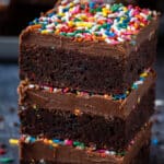 Stack of three rainbow sprinkle brownies.